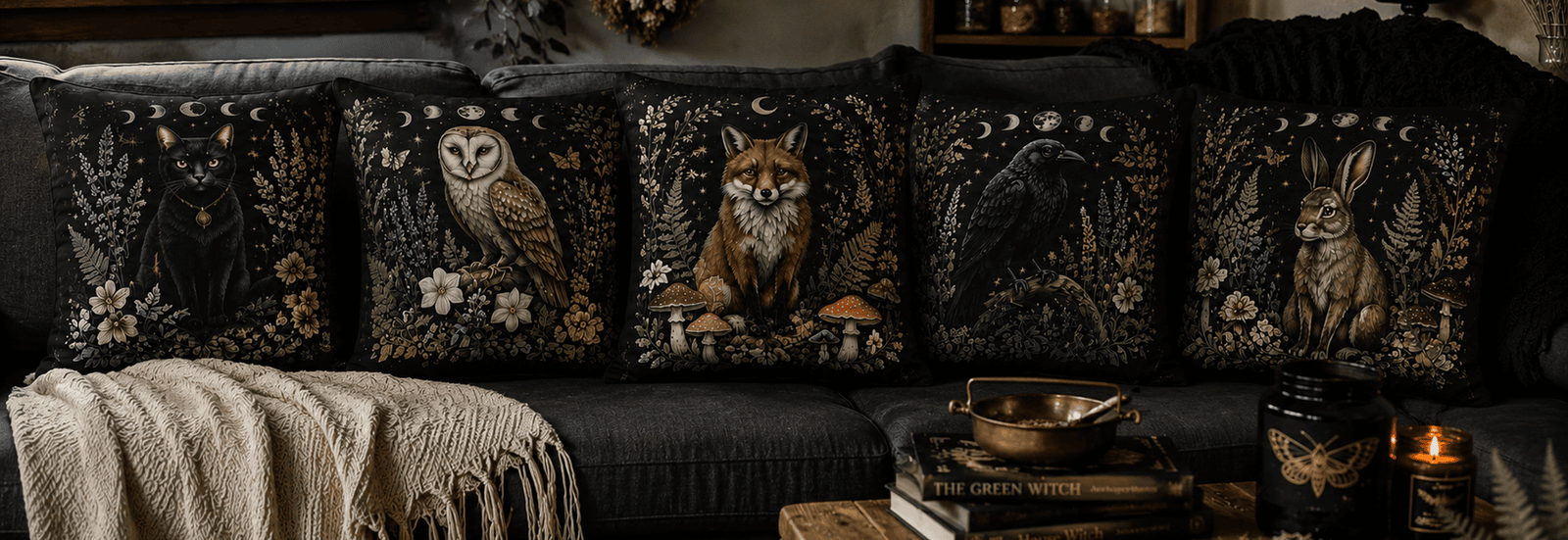 Hero banner featuring The Faithful Familiars Collection decorative throw pillows displayed on a charcoal sofa in a cozy witchcore living room with botanical décor, candles, and natural lighting.